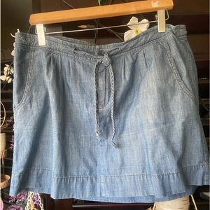 vintage denim mini skirt with buttoned zip ties & pockets on ea side regular fit